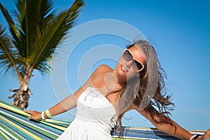 Young beautiful woman relaxing on the hammock