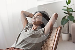 Young beautiful woman relaxing at home. Cute african american girl resting in her room photo