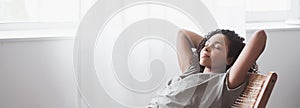 Young beautiful woman relaxing at home panoramic banner. Cute african american girl resting in her room.