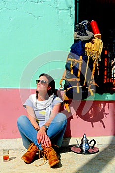 Young beautiful woman resting and taking a cup of tea ,Atlas mountains, Morocco.