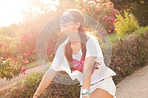 Young beautiful woman riding bicicle on summer photo