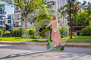 Young beautiful woman riding an electric scooter to work, modern girl, new generation, electric transport, ecology