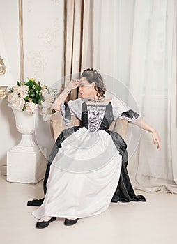 Young beautiful woman in rococo style medieval dress fainted in