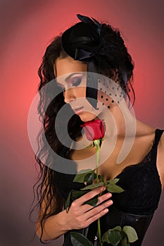 Young beautiful woman with rose in her