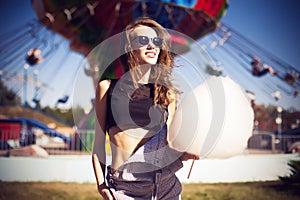 Young beautiful woman in round hipster sunglasses and with long