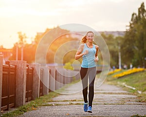 Young beauty woman running in park in the morning