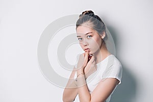 Young beautiful woman serious and concerned looking worried and thoughtful facial expression feeling depressed