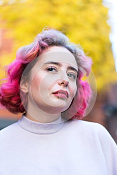 Young beautiful woman with short pink hair. Closeup portrait