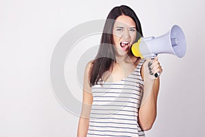 Young beautiful woman shouting through a megaphone