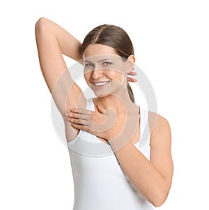 Young beautiful woman showing armpit with smooth clean skin on background