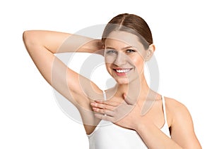 Young beautiful woman showing armpit with smooth clean skin on background