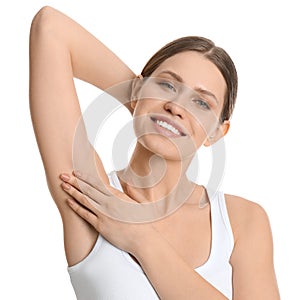 Young beautiful woman showing armpit with smooth skin on white background