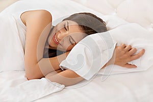 Young Beautiful Woman Sleeping on Bed