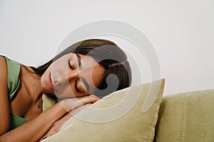 Young beautiful woman sleeping on sofa at home