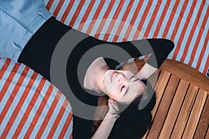 Young beautiful woman smile and relax on the ground for picnic time.