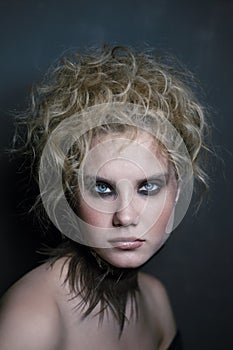 Young beautiful woman with smoky eye makeup and prom hairdo