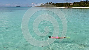 Young beautiful woman snorkeling in tropical water on vacation