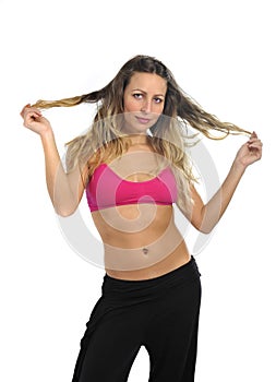 Young beautiful woman in sport clothes posing seductive with top bra in fitness concept