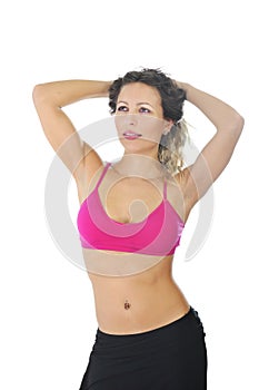 Young beautiful woman in sport clothes posing seductive with top bra in fitness concept