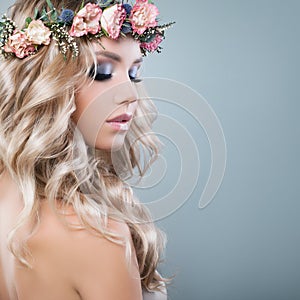 Young Beautiful Woman in Spring Flowers Wreath