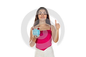 Young beautiful woman standing with piggy bank money box