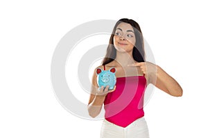 Young beautiful woman standing with piggy bank money box