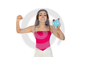Young beautiful woman standing with piggy bank money box