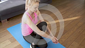 Young beautiful woman stretching at home in the morning