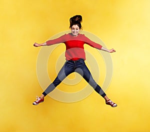 Young beautiful woman in studio, jumping.