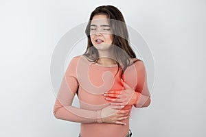 Young beautiful woman suffering from heartache looking helpless on isolated white background, healthcare concept