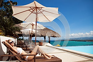 Young beautiful woman sunbathing. Nice sea view.