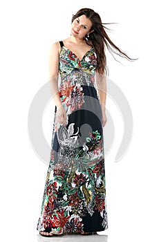 Young beautiful woman in sundress with colorful flower pattern, long hair, full body portrait