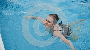 Young beautiful woman in the swimming pool.