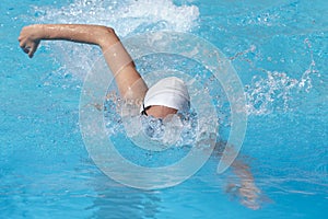 Young beautiful woman with swimsuit swimming on a blue water pool