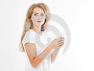 Young beautiful woman in t shirt using her smartphone isolated on white background. blond girl chating with friend