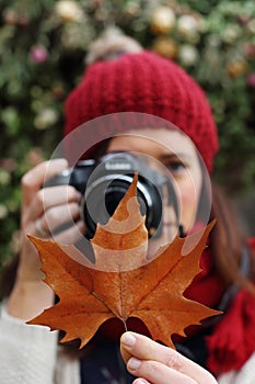 Young beautiful woman takes pictures to beech leaves in one of the most amazing beech forest in Europe, La Fageda d'en Jorda.