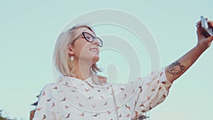 Young beautiful woman taking selfies with her smartphone