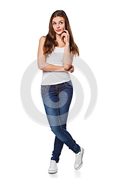 Young beautiful woman thinking looking to the side at blank copy space, full length, isolated over white background