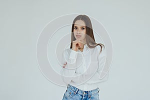 Young beautiful woman thinking looking to the side at blank copy space over white background