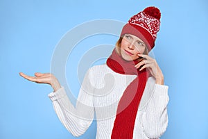 Young beautiful woman thinking looking to the side with showing open hand palm at blank copy space, Christmas girl wearing hat and