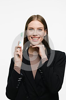 Young beautiful woman with toothbrush isolated on white background