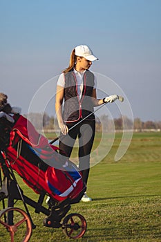 Young beautiful woman is training golf