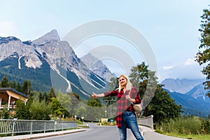 Young beautiful woman traveler , mountains Alps background,