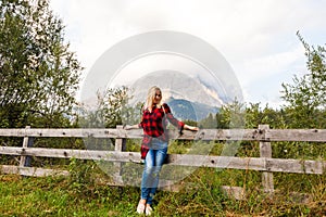 Young beautiful woman traveler , mountains Alps background,