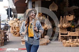 Young beautiful woman traveling at the local market during vacation. Tourist women travel in Chiang mai enjoy shopping