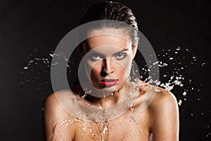 Young beautiful woman under the stream of water