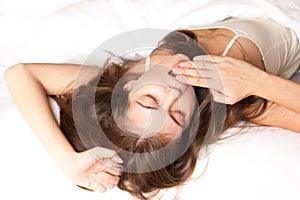 Young beautiful woman waking up not fully rested