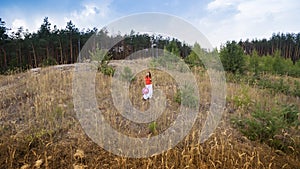 Young beautiful woman walking through a field