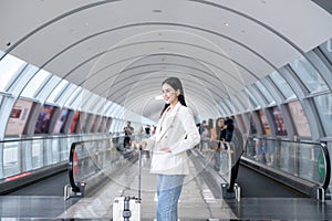 Young beautiful woman walking with suitcase , check in at International airport , vacation travel and transportation concep