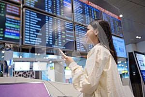 Young beautiful woman walking with suitcase , check in at International airport , vacation travel and transportation concept